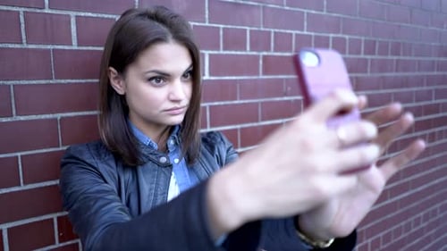 Young Beautiful Caucasian Woman Using Smart Phone in the City