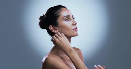 Elegant Woman Poses with Hands on Neck