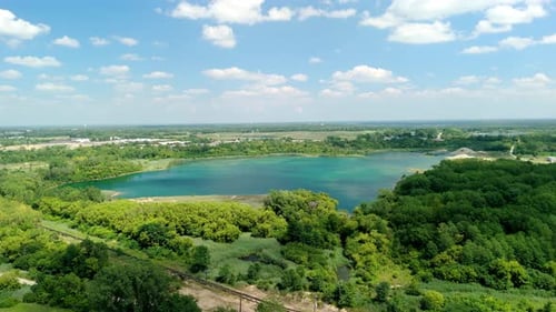 Wide Drone Aerial Footage of Countryside Natural Green Blue Pond or Lake