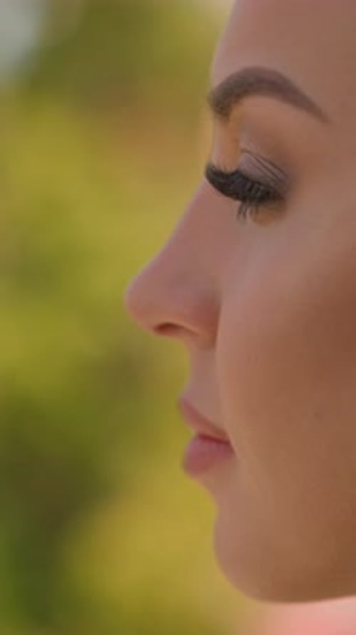 Happy Woman with Curly Hair on Blurred Green Background