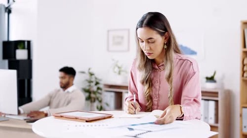 Woman Taking Notes at Modern Office Workspace