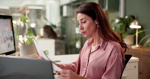 Woman Reviews Documents at Modern Office Desk