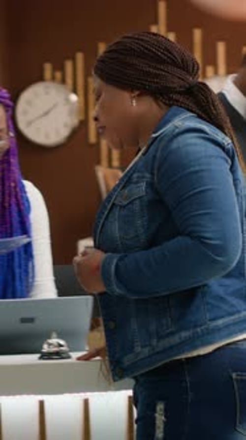 Hotel Receptionist Checking in a Customer