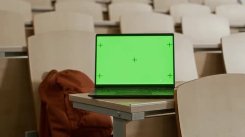 Green Mockup Display of Laptop Placed on Desk in College Lecture Hall