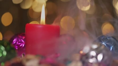 Festive Christmas Candle with Colorful Ornaments and Bokeh