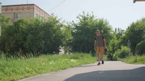 Young Man Walks on a Sunny Day