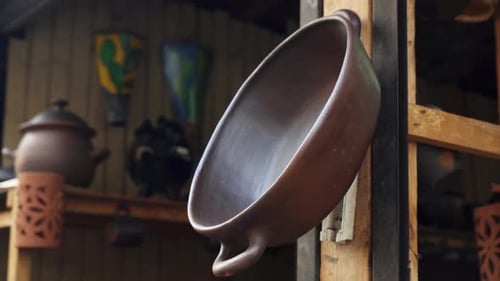 Pomaire Pottery - Clay Pot With Handle Hanging On Wooden Post Inside A Store In Pomaire, Chile. - cl