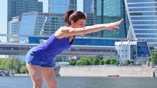 Woman Doing Stretches in an Urban Environment