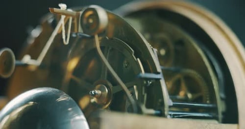 Slow motion macro close up of an old vintage clock luxury mechanism movement.