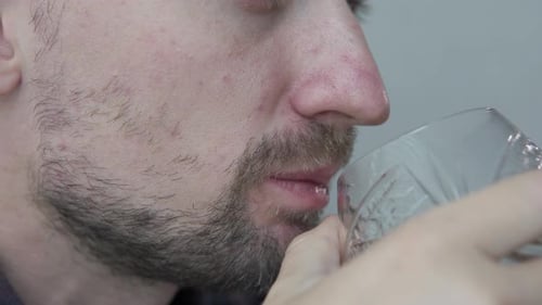 Adult Male Drinking from Glass in Close Up