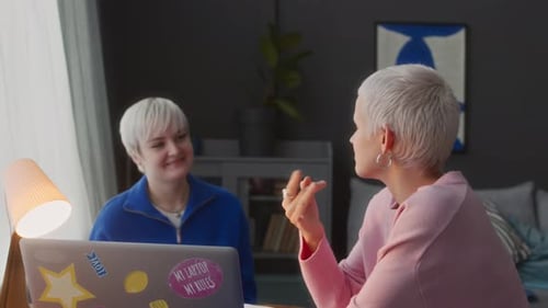 Two Women Talking in a Bright Room