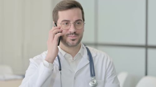 Doctor Speaks on Smartphone in Clinic Setting