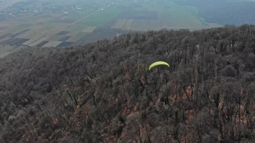 Take to the skies and explore the mountains from a paraglider's perspective.