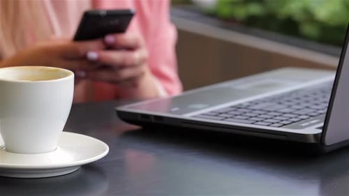 Girl Using Her Mobile Phone in Cafe
