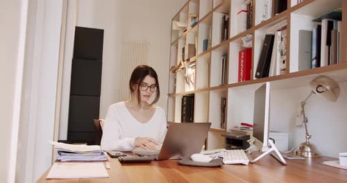 Young Business Woman in Glasses Working in Office Interior on Pc on Desk Typing
