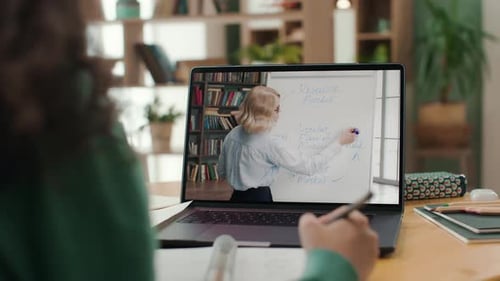 Online Education of University Student Using Laptop in Home Interior. Remote Study