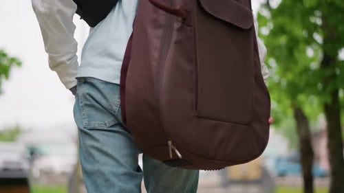 Casual Guitarist Carrying Padded Bag Relaxed Musician in Denim Enjoying Daylight Walk Casual Artist