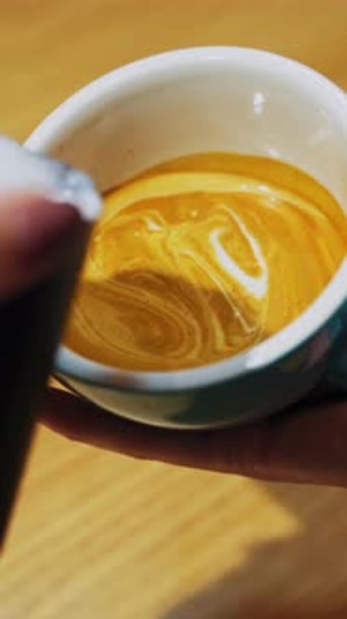 Milk Being Poured Into Coffee Cup
