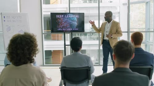 Public Speaker Showing Presentation for his Colleagues