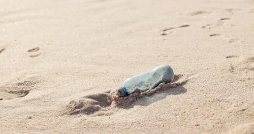 Beach, sand or plastic bottle in nature for pollution, climate change or global warming closeup