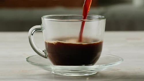 Coffee Pouring into Clear Mug in Kitchen