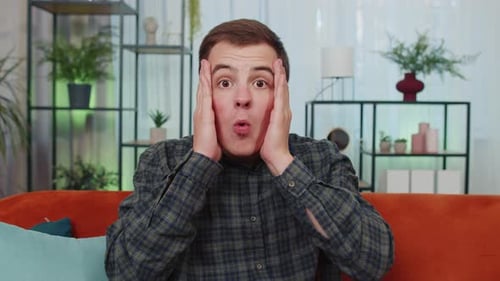 Man Reacts with Surprised and Worried Facial Expressions