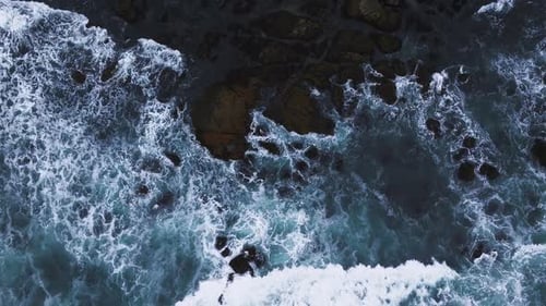 Aerial View of the Pacific Ocean Waves Hitting the Cliff Rocks