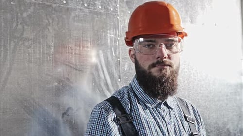 Man with Beard Wearing Hard Hat and Goggles
