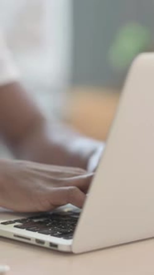 African Man Typing on Laptop, Close up, Vertical Video