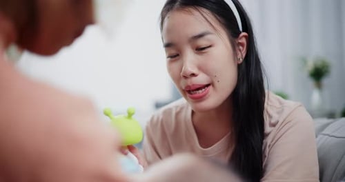 Loving Parents Interact with Baby on Sofa