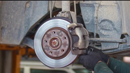 Replacing Front Brake Pads In A Car Repair Service