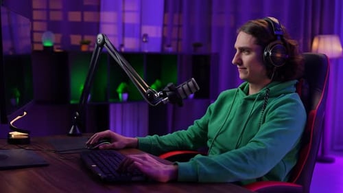 Young Adult Gamer Using Computer at Night