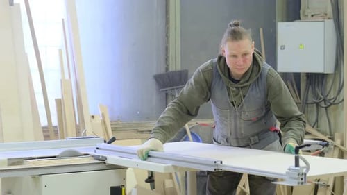 Close Up Carpenter at Workshop Polishes Wooden Board with a Electric Orbital Sander Woodwork and