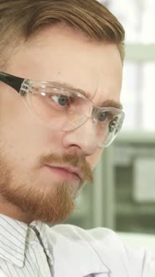 Man Working Carefully in Bright Laboratory Setting