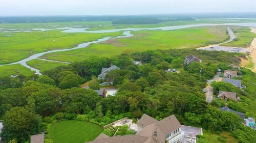 Aerial Drone View of Beachfront Homes and Marshland on a Cloudy Day