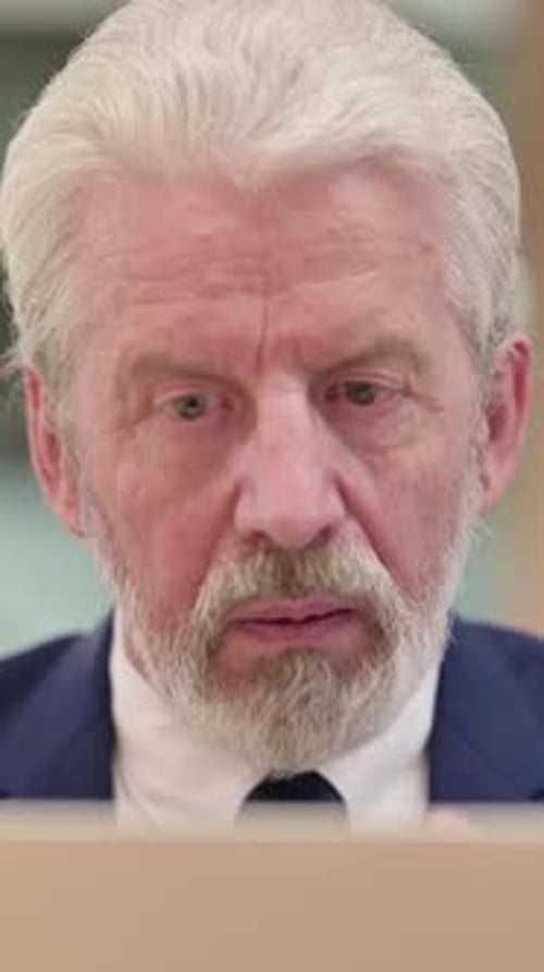 Close up of Senior Old Businessman doing Video Chat on Laptop, Vertical Video