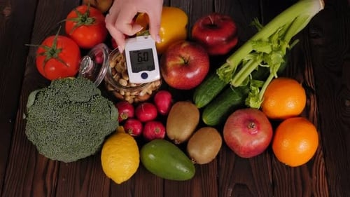Glucose Meter with Fresh Raw Vegetables and Fruits