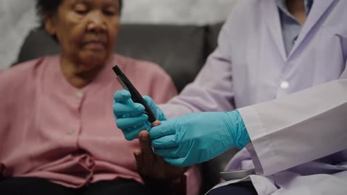 close up doctor using glucometer checking blood sugar level of senior woman. check diabetes concept
