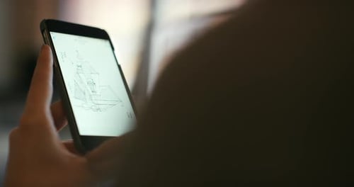Hands using Smartphone to Review Building Designs