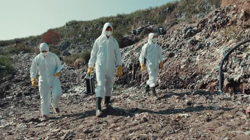 Scientists Inspecting Garbage Landfill in Protective Suits