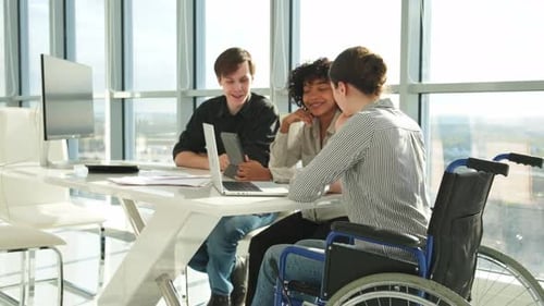 Team Discussing Project at Bright Modern Workplace