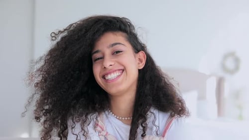 Smiling Woman with Curly Hair Posing