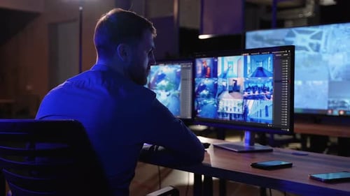 Man Officer In Control Room Monitoring CCTV Footage