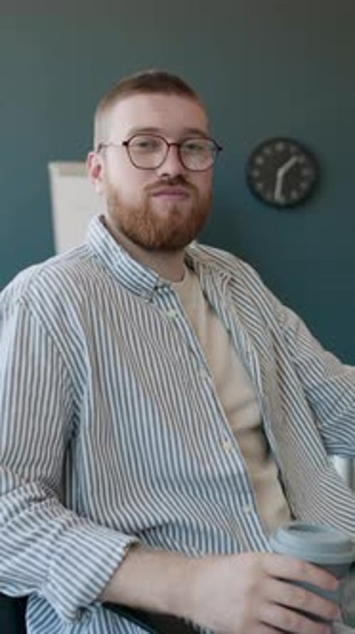 Young Office Worker With Cup Of Coffee