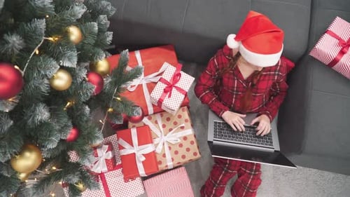 Girl Shopping Online for Christmas Presents at Home