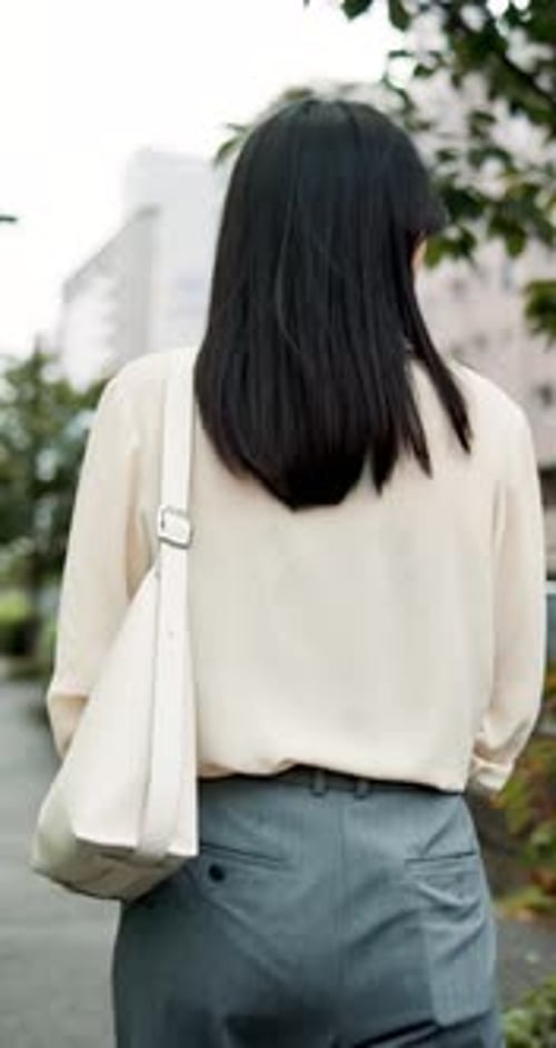 Woman, worker and walking in town of Japan, travel and employee commute on street to workplace