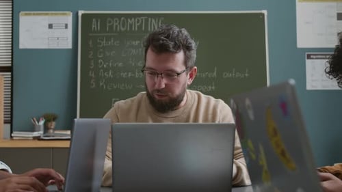 Male Teacher Explaining Rules of AI Prompting to Students at Practical Lesson
