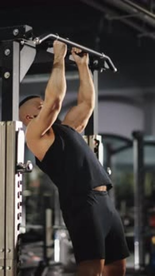 Muscular Athlete Executing Demanding Pullups Showcasing Peak Physical Strength While Training Inside
