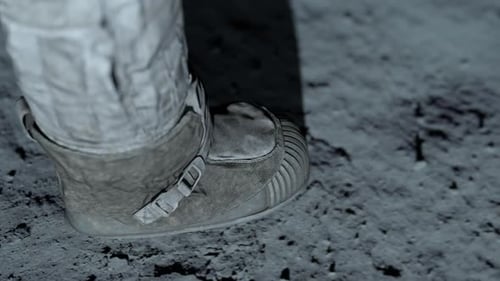 Astronaut Boot Stepping on Lunar Surface Leaving Footprint