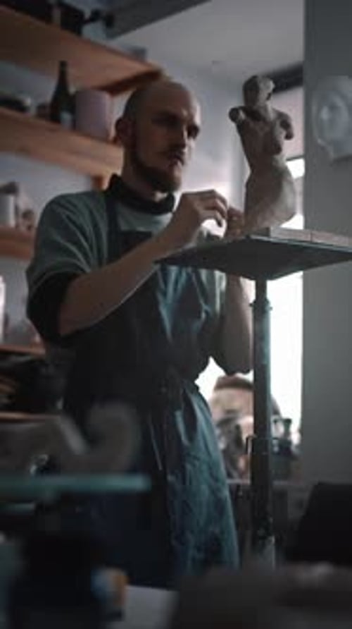 Fulllength Portrait of a Skillful Man Potter Creating a Clay Statue in His Author's Art Workshop